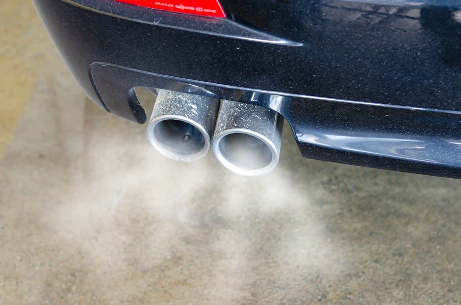 Car exhaust pipe emitting visible emissions