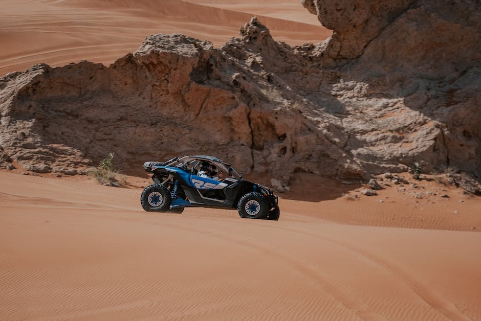 A person driving an off-road vehicle through rocky terrain, showcasing the importance of off-road drivetrain dynamics.